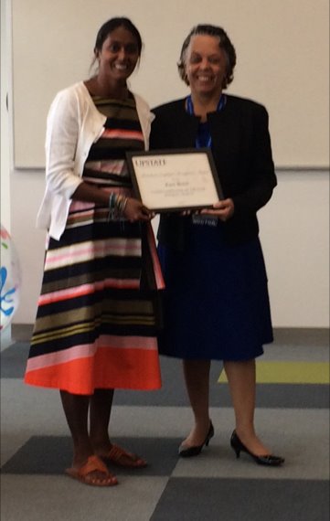 Kara receives her award from Dr. Laraque-Arena