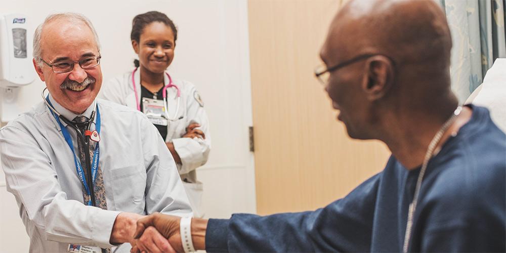 Dr. Stephen Graziano, medical oncologist, greets a patient. Upstate Medical Oncology treats cancer and other hematologic conditions with infusions including chemotherapy in Syracuse, Oneida and Oswego.
