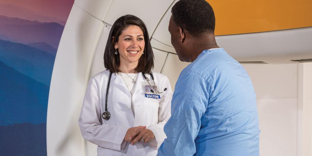 Radiation Oncologist Anna Shapiro speaks with a patient about treatment using TrueBeam, a type of stereotactic radio therapy