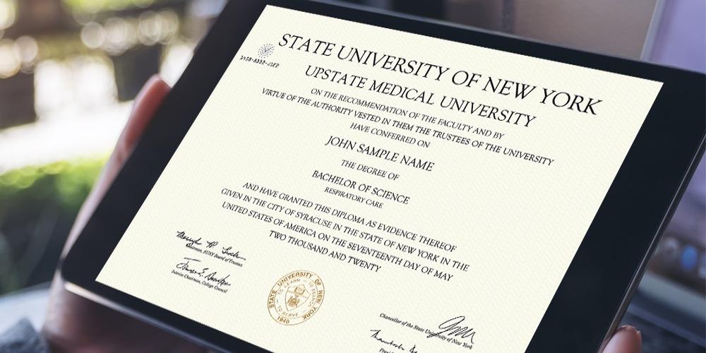 A person holding a tablet with their diploma displayed