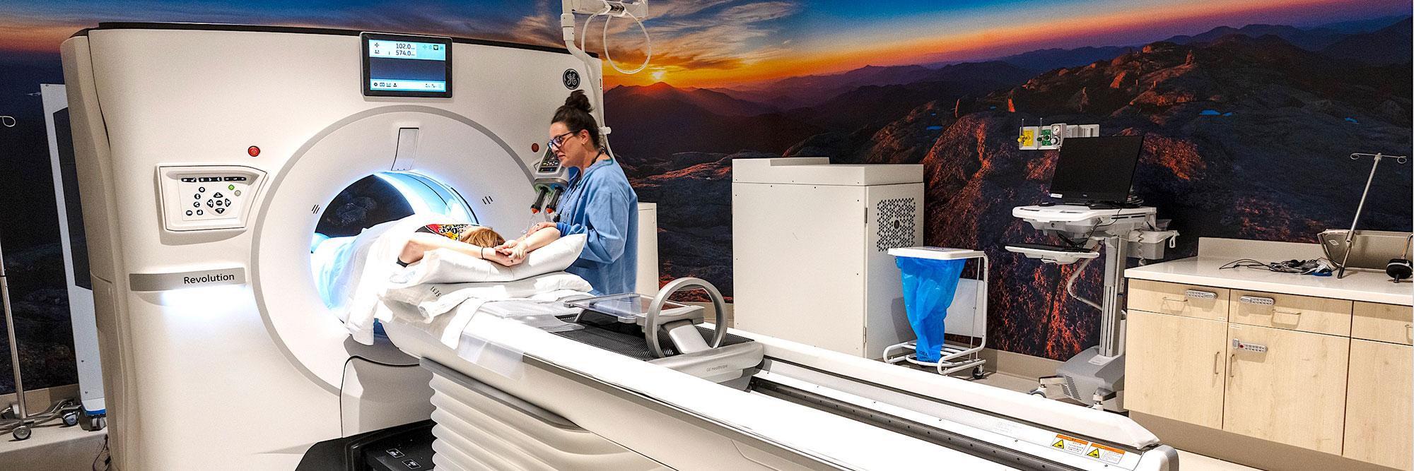 Technician and patient interacting with a CT Scanner