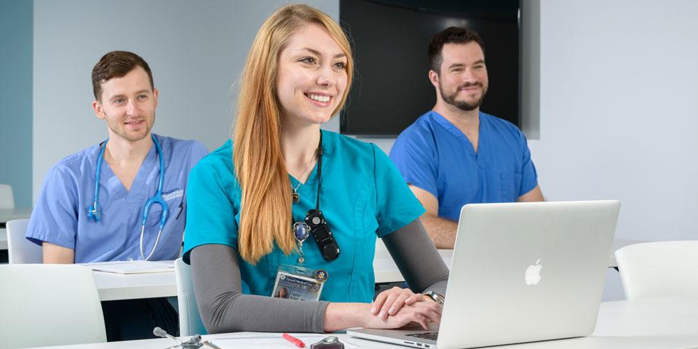 Classroom featuring similing nursing students
