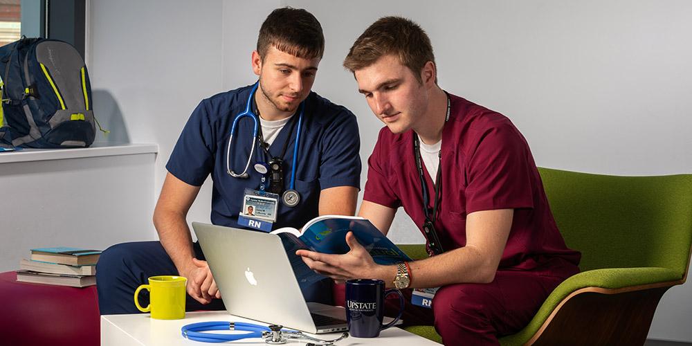 Ryan and Corey working together at computer