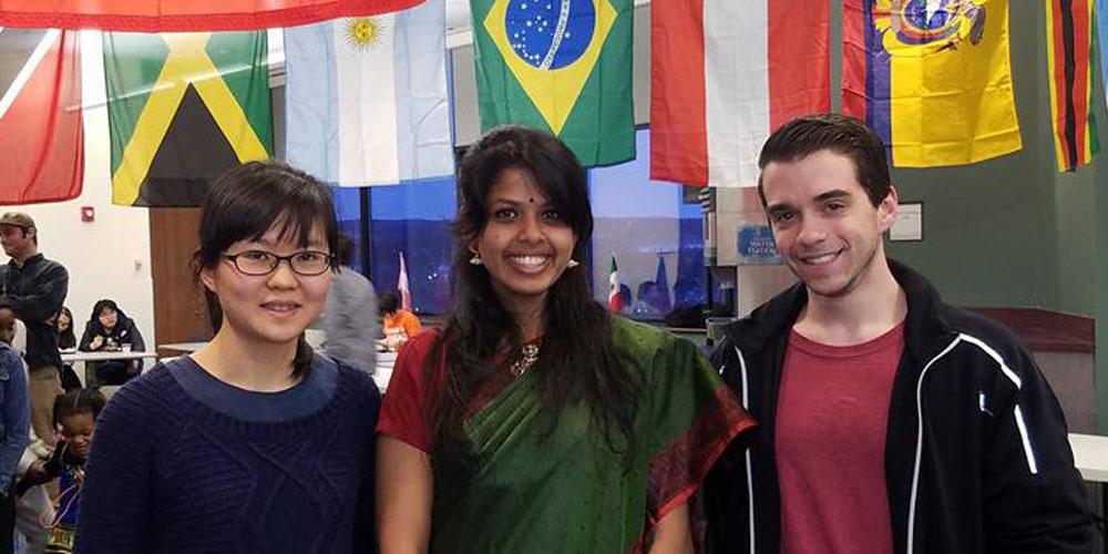 Students behind flags at International Festival