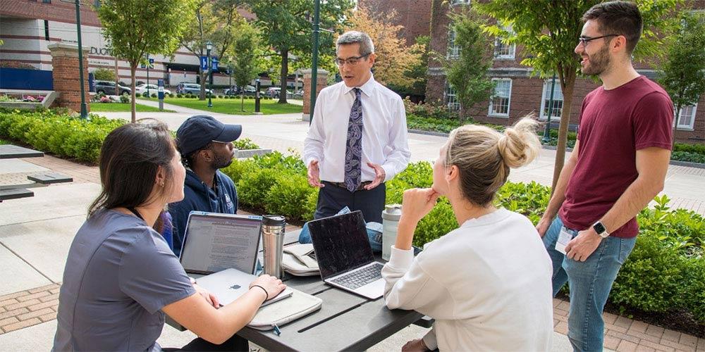 About Dean Lawrence Chin, MD with students
