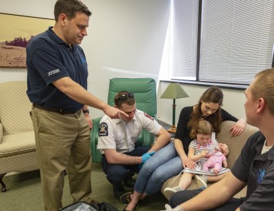 Physician instructor guides paramedic students in a simulation