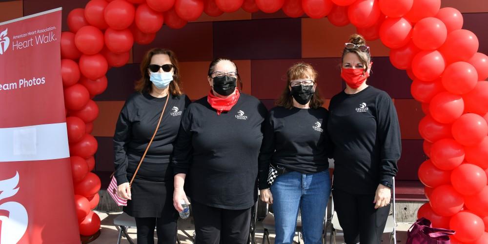 photograph of four emergency medicine staff members who walked in the 2022 American Hearth Association's Heart Walk at Onondaga Community College.