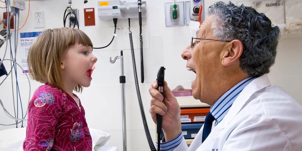 Dr. Cantor checking tonsils