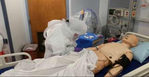 Nurse caring for a mock ebola patient.