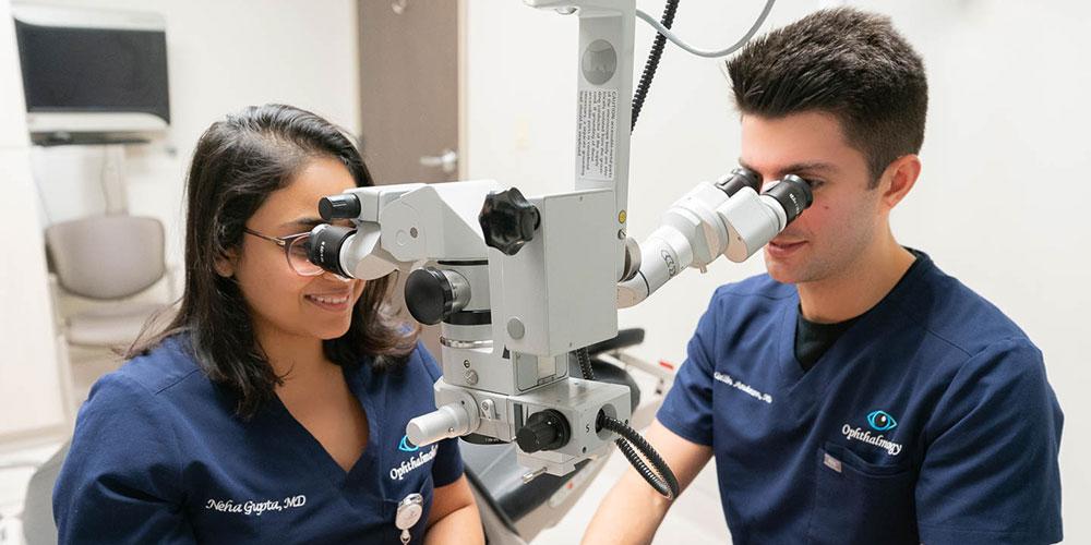 Residents utilizing ophthalmology equipment