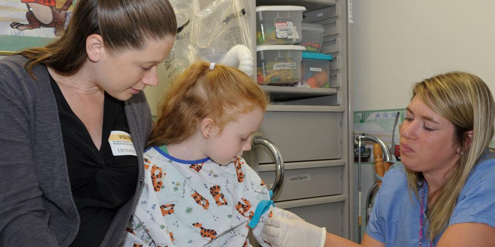mother and daughter with nurse at surgery center