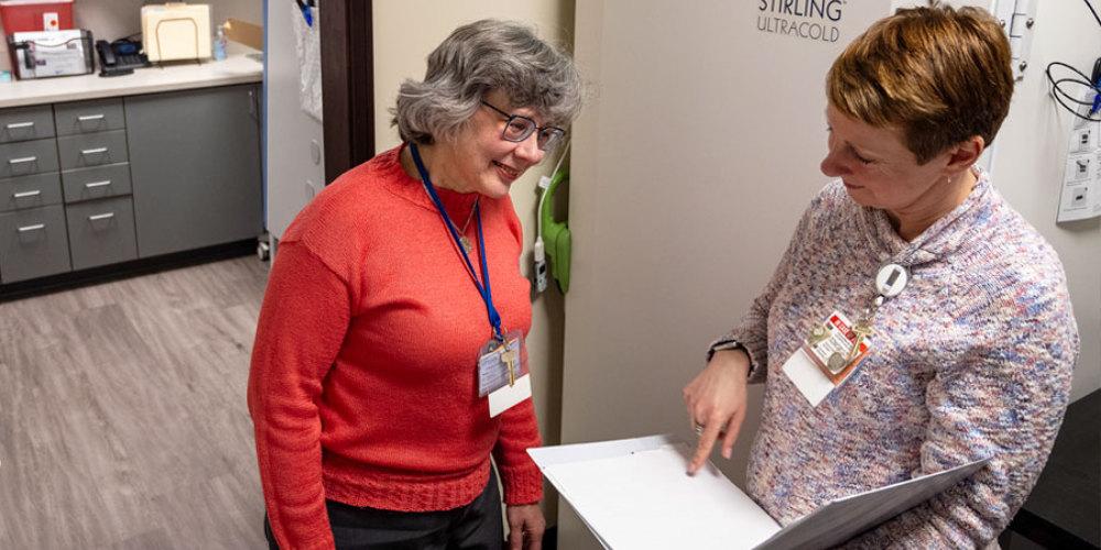 Two people in Lab discussing support of the institute