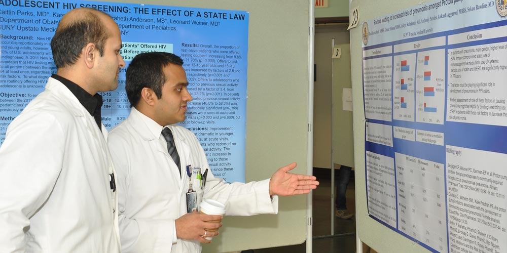 Residents Discussing Research Poster