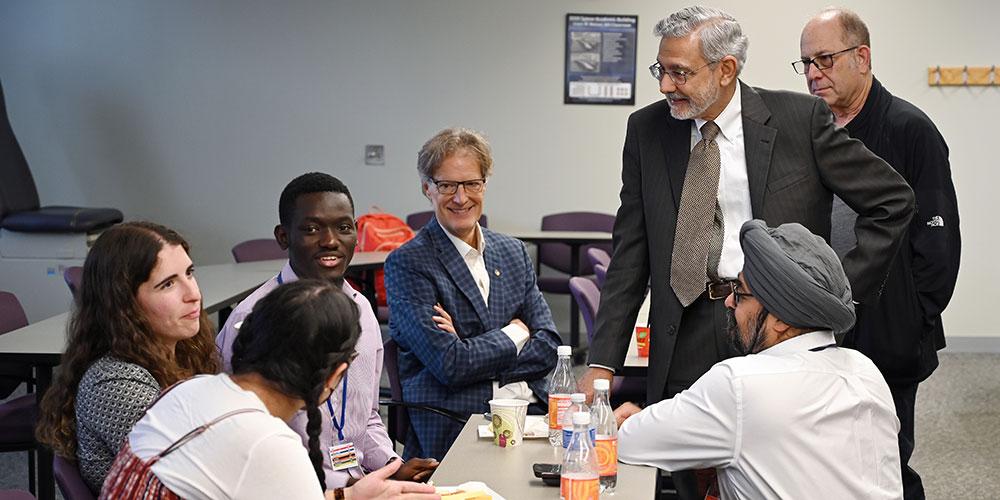 Dean of Graduate Studies with SUNY Upstate President Dr. Mantosh Dewan and students at a Grand Rounds discussion