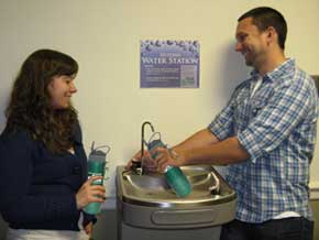 students filling reusable water bottles from a filtered fountain
