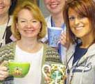 Radiation Oncology Department members who have gone green with coffee mugs.