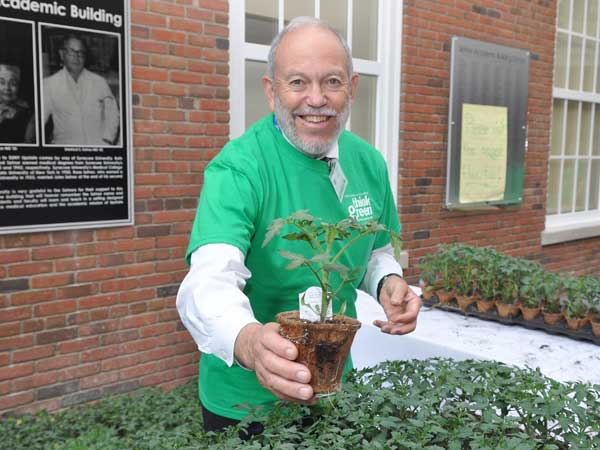 Gary Kitell handing out tomato plants