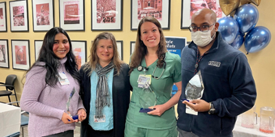 Heather O’Hearn, Program Administrator for Family Medicine Residency at Upstate Community, presents awards to three residents.