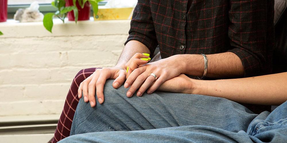 Comforting a patient - holding their hands.