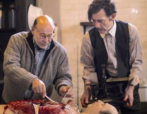 Adviser Stanley Burns, MD, instructs actor Clive Owen on historical accuracy on the set of the Cinemax series The Knick, set in a New York City hospital in 1900. (PHOTOGRAPH BY MARY CYBULSKI / CINEMAX)