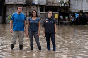 Anna Stewart Ibarra, PhD (center), is shown in flooded Machala, Ecuador, in early 2016. She was also part of earthquake relief efforts in Ecuador, where she conducts research. (PHOTO BY DANY KROM)