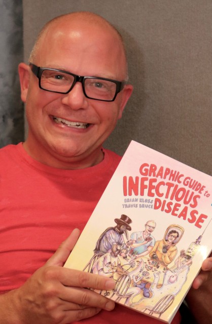 Brian Kloss, DO, with his new book (photo by Jim Howe)