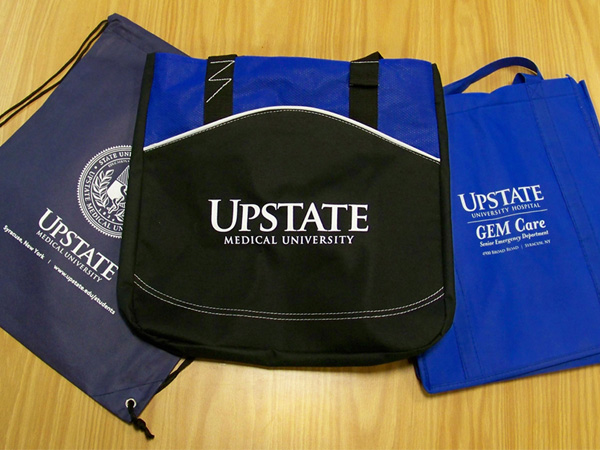 Bags, backpacks, travel mugs, band-aid containers, keychains, etc. show a consistent Upstate brand, thanks to artwork created by Marketing