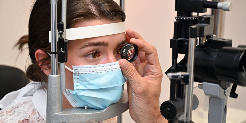 Patient looking through lens in eye test