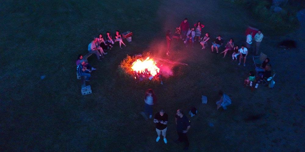 A bird's eye view of residents enjoying a bonfire.