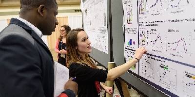 Rose Pasquale explains her research poster at the annual meeting of the Association for Research in Vision and Ophthalmology (ARVO) in Baltimore, Md.
