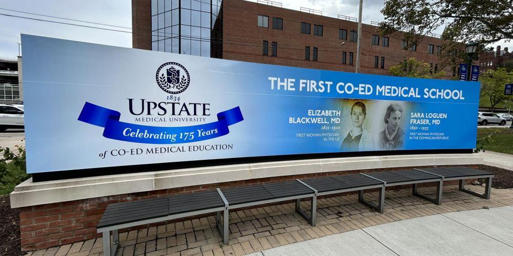 A BLACKWELL FIRST: New signage outside of Weiskotten Hall celebrates Upstate Medical University’s title as the first coed medical school in the nation. This January will be the 175th anniversary of Elizabeth Blackwell earning her medical degree. Blackwell graduated from Geneva College of Medicine, which today is Upstate Medical University.