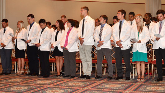 Upstate Medical University medical students receive their white coats during ceremony Aug. 9