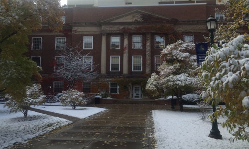 Early snow paints Weiskotten Hall courtyard white