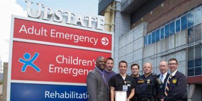 SPD Chief Fowler and SWAT Commander Belgrader present Seth Dukes, MD, with service award