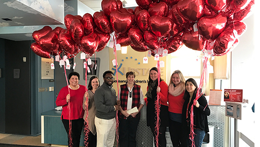 Staff from the S. I. Newhouse School of Public Communications at Syracuse University brightened Valentine's Day for patients at Upstate Golisano with a red heart-shaped balloons.