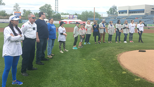 Members of the Upstate's Comprehensive Stroke Center and EMS partners stand in the field at NBT Bank Stadium during Syracuse Chiefs Strike Out Stroke Night.
