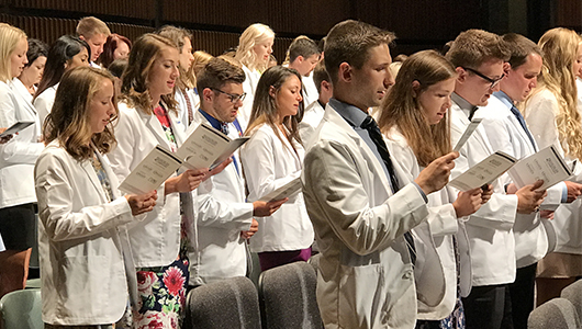 Students recite the Oath of the Health Professions during the White Coat Ceremony for students pursuing studies in the allied health fields, among them physical therapy, medical imaging, radiation and respiratory therapy.