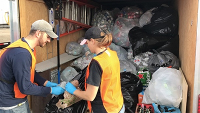 Volunteers fill another truck load of bottles and cans dropped off at DestinyUSA for the Cans for Cancer drive Oct. 23.