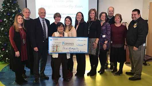 Paige's Butterfly Run presents $210,000 donation for pediatric cancer care, research