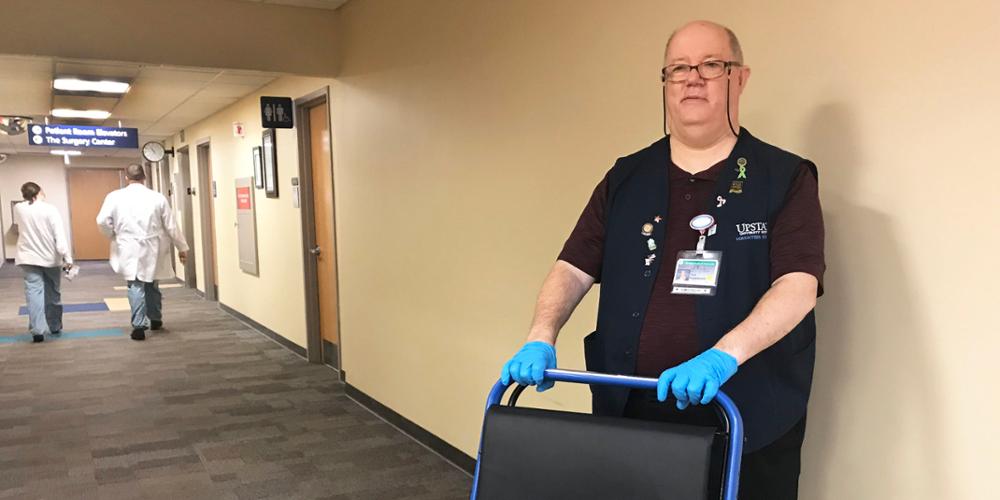 Paul Fisselbrand has been a volunteer at the Upstate University Hospital's Community Campus for 17 years. Here he stands with a wheelchair, ready to transport a patient.