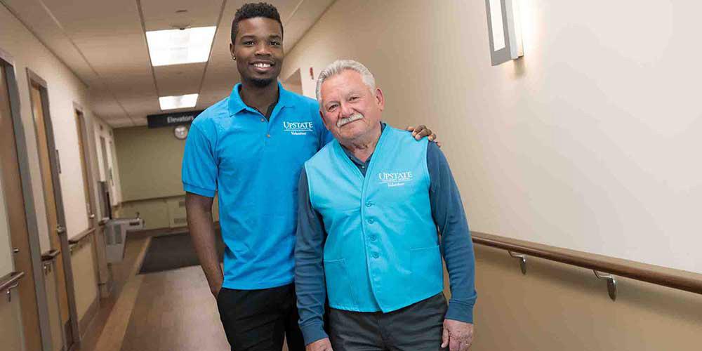 Two Upstate University Hospital employees model the new uniforms.