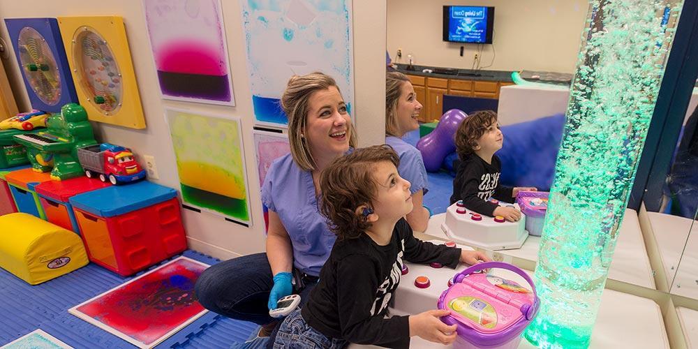 A behavior analysis studies student works with a young patient.