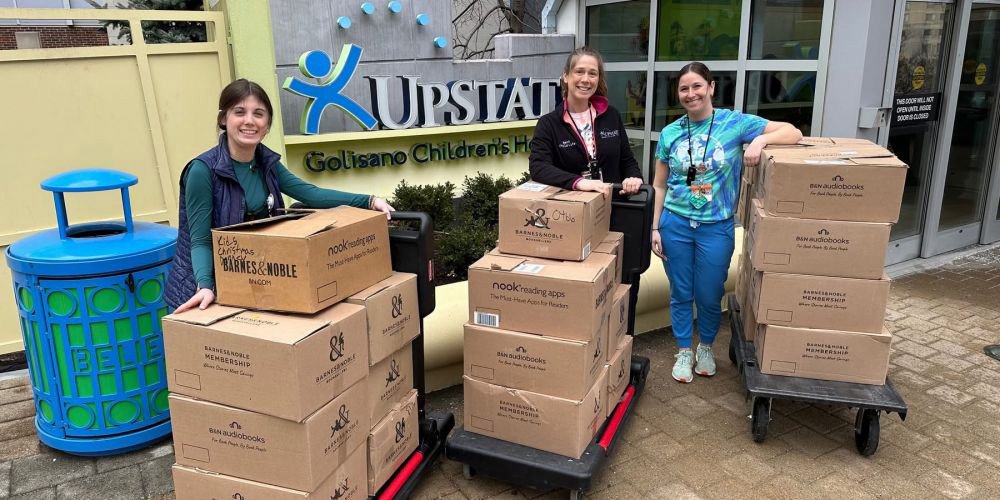Upstate Golisano Children’s Hospital Child Life members receive a book drop off from the Cicero North Syracuse High School Student Government that were collected for the Paige’s Butterfly Run book drive. The books will be distributed to patients at the children’s hospital. 