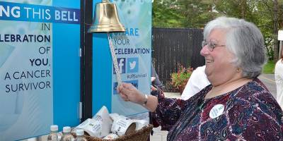 Kathleen Tamer rings the Cancer Survivor's Bell at the celebration honoring more than a quarter-century of care of Upstate Cancer Center at Oneida. Tamer, was originally treated for Non-Hodgkins Lymphoma. She has been cancer free for 13 years.