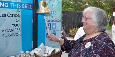 Kathleen Tamer rings the Cancer Survivor's Bell at the celebration honoring more than a quarter-century of care of Upstate Cancer Center at Oneida. Tamer, was originally treated for Non-Hodgkins Lymphoma. She has been cancer free for 13 years.