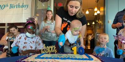 Cutting the cake in celebration of 10th birthday at Upstate Golisano/