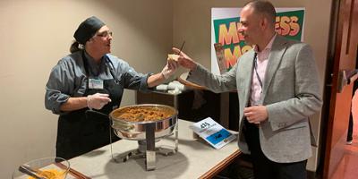 Dr Jarrod Bagatell, director of student and employee health, takes a taste of vegan chili during Upstate Medical University's Meatless Monday tasting.