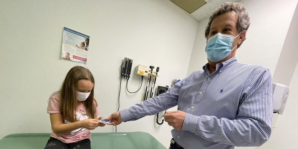 VACCINES ARE IN: 7-year-old Jaelynn of Fayetteville was among the first patients to get a COVID 19 vaccine at the Upstate Pediatric and Adolescent Center. With her is Dr Steven Blatt.