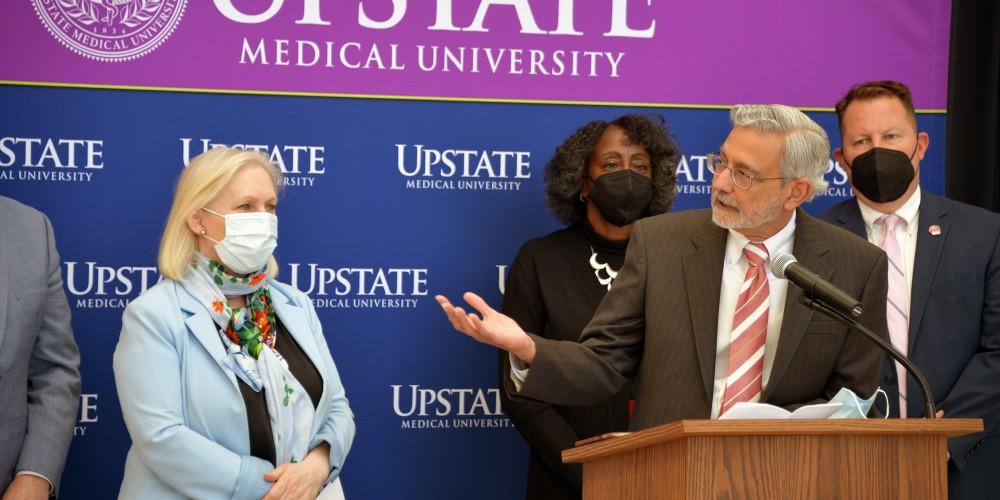 SENATORIAL VISIT: Upstate Medical University President Dr. Mantosh Dewan acknowledges the work of U.S. Sen. Kristen Gillibrand, during the senator’s visit to Upstate April 29. Gillibrand chose Upstate to highlight her efforts at lowering prescription drug costs.