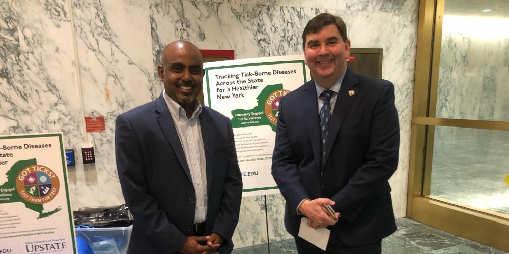 LYME DISEASE OUTREACH: Upstate Professor Saravanan Thangamani, PhD., left, with State Sen. John Mannion at Lyme Disease Awareness Day in Albany to showcase Upstate’s efforts in Lyme disease prevention and tick surveillance. In its citizen science program, Thangamani’s lab receives ticks from all across the state to be analyzed to see if they are carrying disease.
